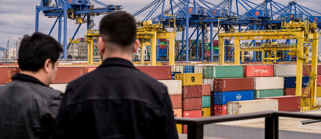 Imagem conceitual de duas pessoas observando o porto de Itajaí, cidade onde acontece o curso sobre importação para e-commerce estruturado e com margem